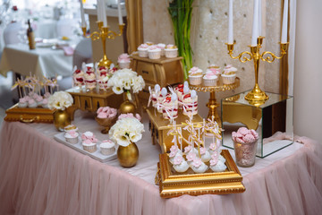 Candy bar. Table with sweets, buffet with cupcakes, candies, dessert.