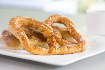 Pretzel bread white sesame in white dish  on gray background, Blurred and Selective focus ..