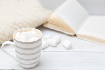 Cup of hot chocolate with marshmallows on a white wooden background. Mock up