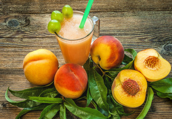 Peach smoothies and peaches. View from above. Wooden table.