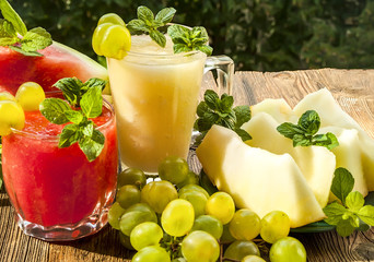 Melon and watermelon smoothies. Pieces of watermelon and melon. close-up. Background blur. Wood surface
