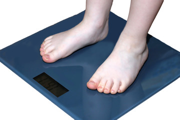 Children overweight, young boy on a bathroom scale,