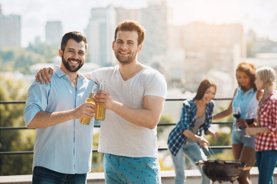 Group of friends having barbecue party on the roof