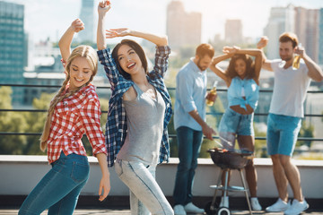 Group of friends having barbecue party on the roof