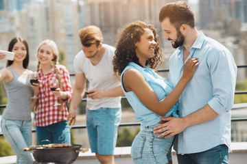 Group of friends having barbecue party on the roof