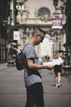 man observing a city map in Zaragoza, Spain