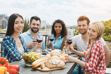 Group of friends having barbecue party on the roof