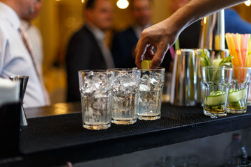 Bartender muddling lime