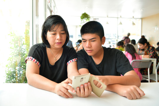 Mother and son use smartphone.