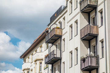 Obraz premium white apartment building with brown balconies