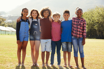 Full length portrait of six pre-teen friends in a park