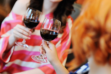 two young women drinking wine in a restaurant. Wine tasting