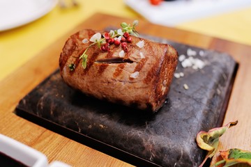 a delicious piece of meat on a stone closeup