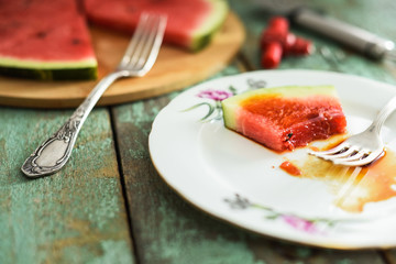 Watermelon slice served on plate with sweet sause. Vegan dessert