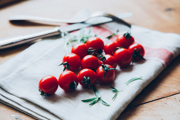 Fresh red tomatoes on a wooden table (toned image)