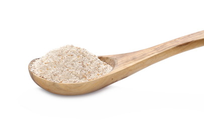 Pile of integral spelt wheat flour in wooden spoon isolated on white background