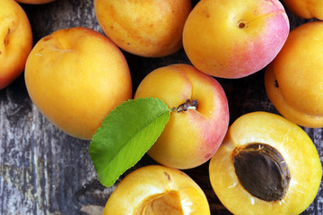 Delicious ripe apricots on wooden table. Fresh cut apricot fruits