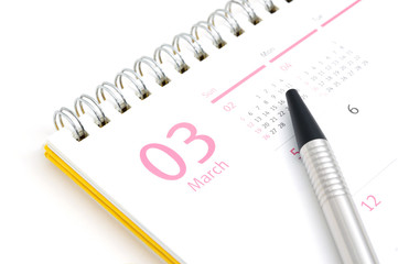 Desk calendar and pen on white background
