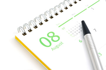 Desk calendar and pen on white background