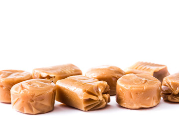 Toffee caramel candies isolated on white background. Copyspace.

