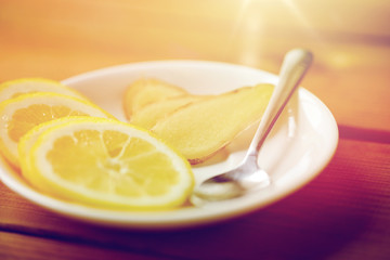 lemon and ginger on plate with spoon