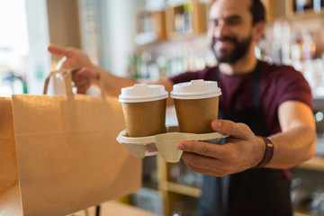 man or bartender serving customer at coffee shop