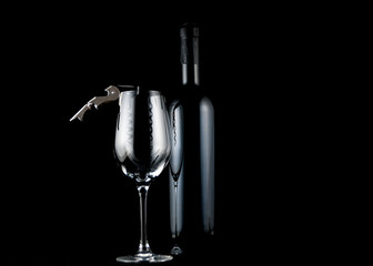 Empty wine glass with corkscrew