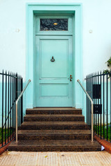Fototapeta premium Classic door of a house with stairs of entrance