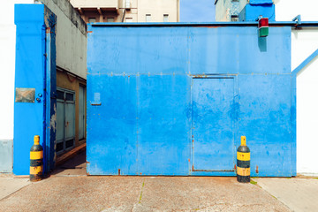 Semi-open metallic garage door of a factory