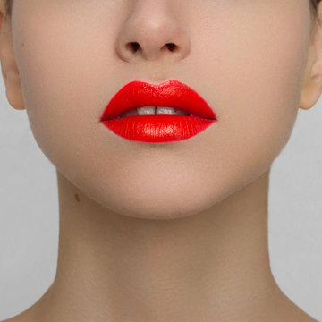 The woman with brightly red chubby lips. Largely open mouth and long neck, pure leather. Increase in lips, cosmetology, make-up