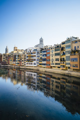 Fototapeta na wymiar Houses in the river and Cathedral, famous landmark in Girona, Catalonia.