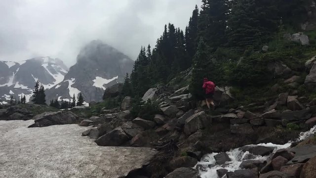 Hiker walks towards the Lake Isabelle Brainard Lake Recreation Area
