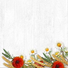 Vintage wooden background with border of wildflowers and ears