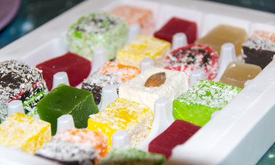 Many assorted multicolored Turkish Delight on white background