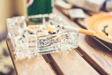 cigarette in glass ash tray