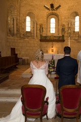 back view of bride and groom during church wedding ceremony