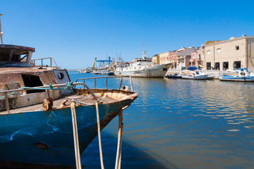 Mazara del Vallo (Italy) - Day view of canal, fishing boats and downtown