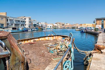 Photo sur Plexiglas Canal Mazara del Vallo (Italy) - Day view of canal, fishing boats and downtown