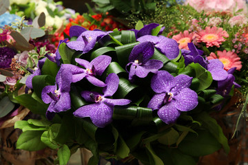 Bouquet of flowers with a dark purple orchids