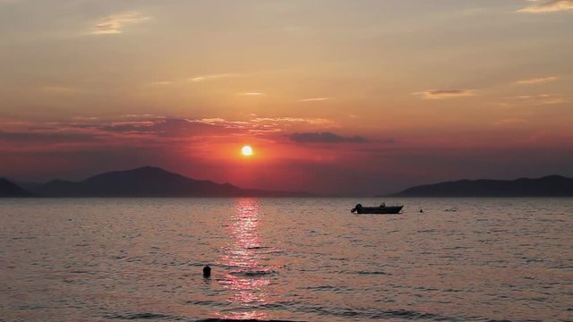 Scenic view of beautiful sunset in the evening time over the sea
Silhouetted shot of beautiful sunset with fisherman boat on the water
