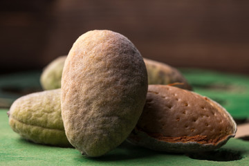 A fresh green almonds in the peel is fresh from the tree. Almonds on a black background. Macro. Fresh Harvest.