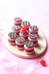 Pink Macarons Filled with Chocolate Ganache and Cherry Confit, decorated with chocolate elements...