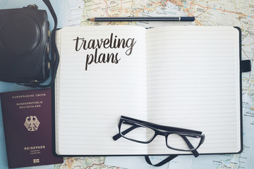 journal on maps with passport and camera travel concept