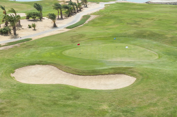 Aerial view of a golf course with green and bunker