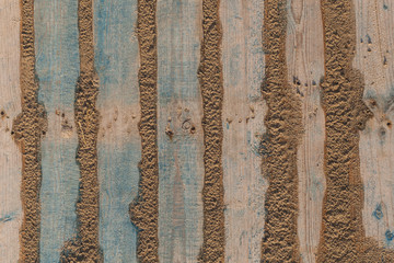 old wood pallet in the sand background texture