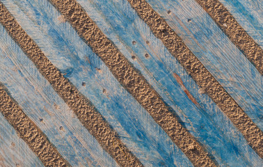 old wood pallet in the sand background texture