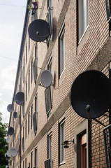 Satellite dishes on a wall of an apartment building in Copenhagen, Denmark.