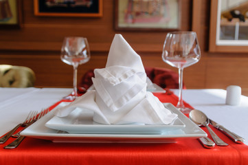 Folded napkin and place settings in a fine dining restaurant