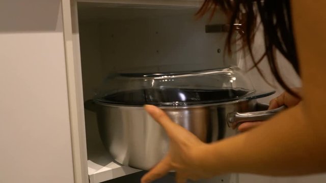 pick up stainless steel pot with lid glass from cabinet