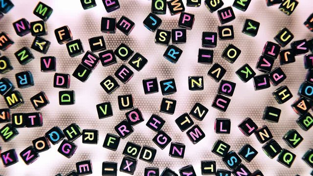 black blocks with colored letters scattered on a white background